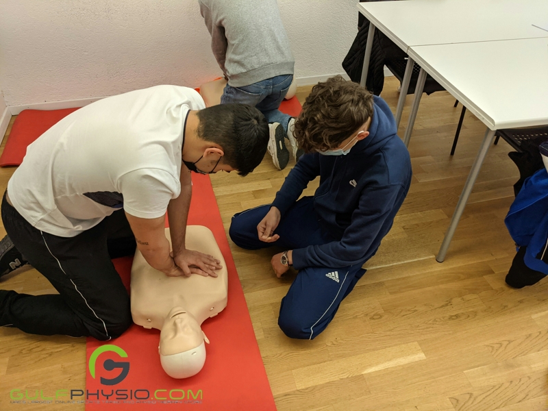 A trainee and instructor in a CPR training class.
