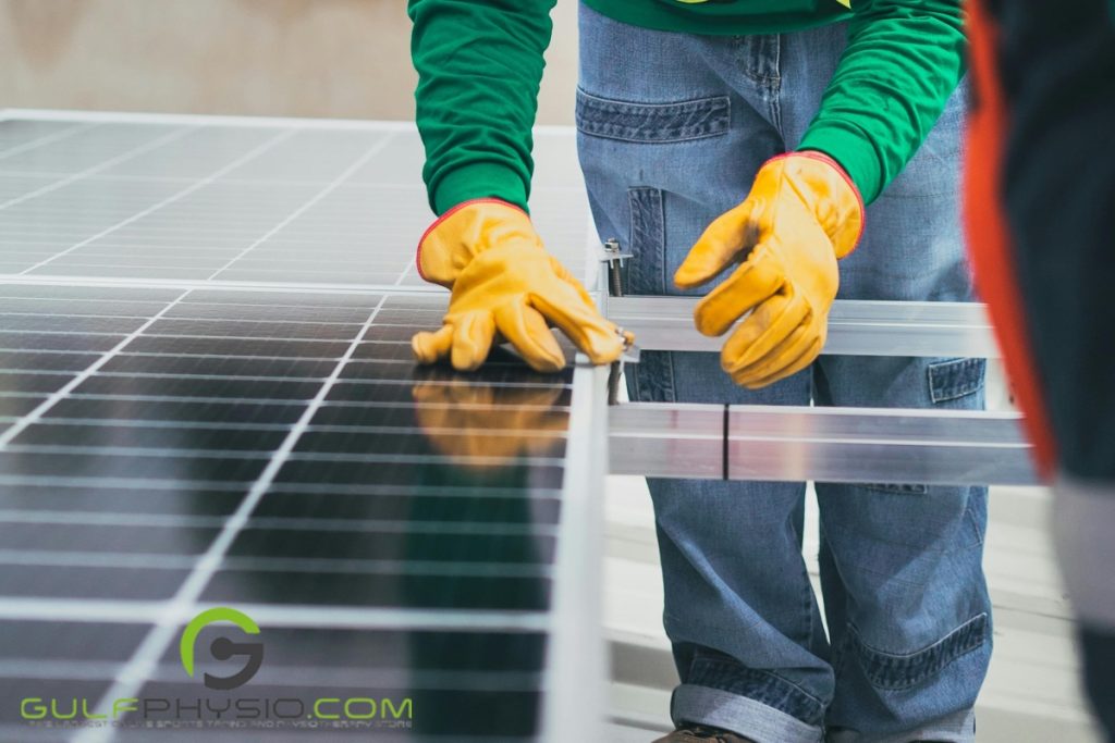 A person is adjusting solar panels with screws and additional paraffin wax