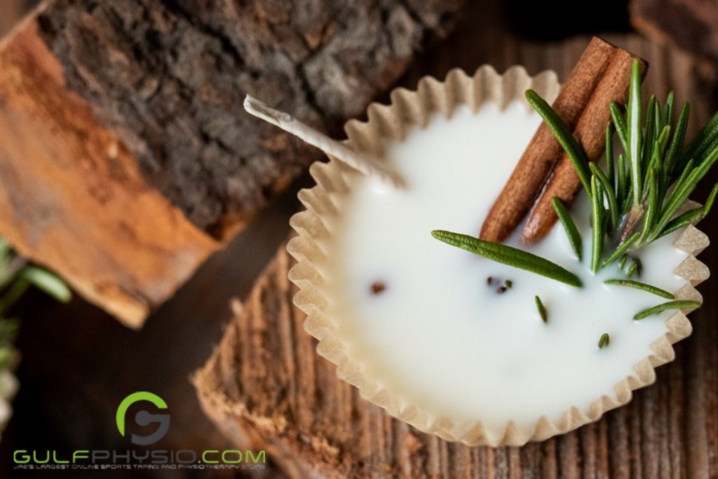 A homemade fire starter with paraffin wax, herbs, and spices, like cinnamon and thyme, on wooden planks