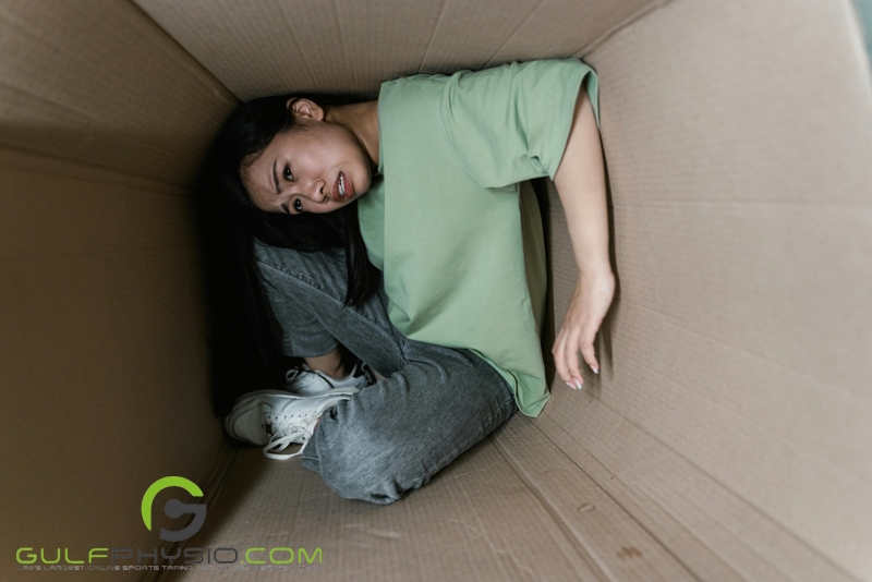 A visual representation of claustrophobia with a woman squeezed in a cramped and tight space, which appears to be a small box