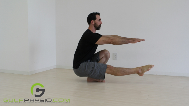 A man successfully doing a pistol squat.