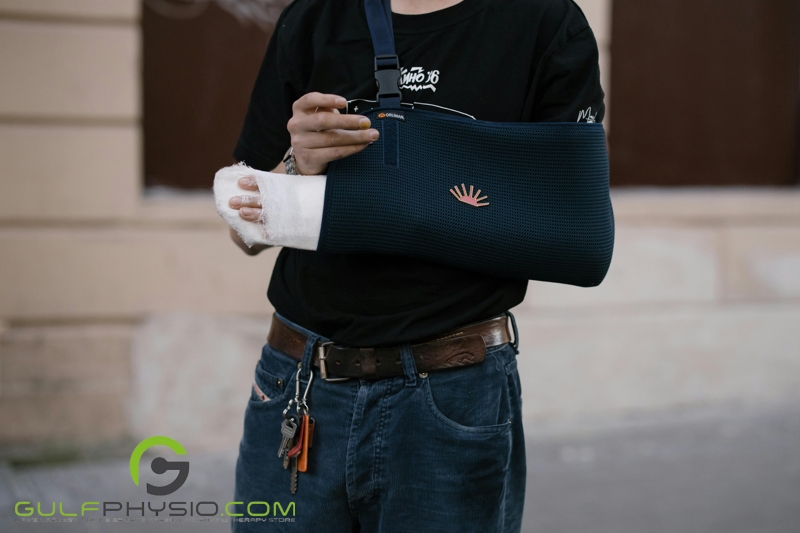 A close-up image of a woman’s injured arm in a cast and an arm sling.