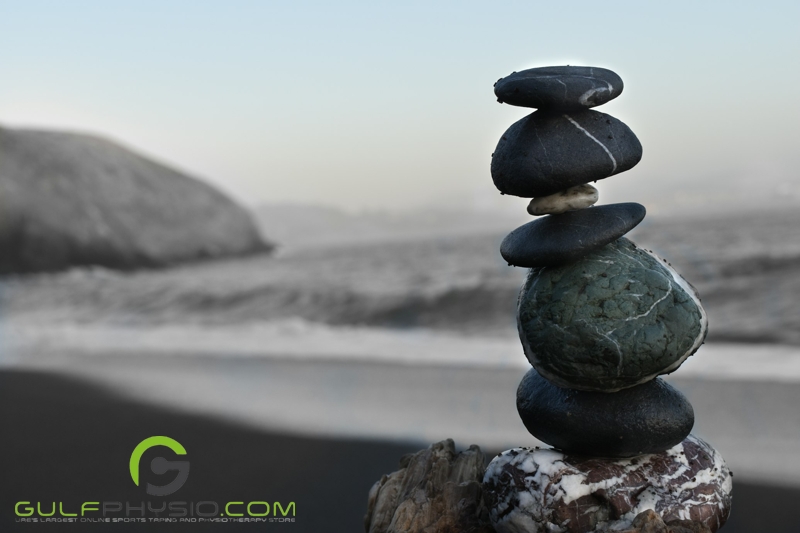 Pebbles that are balanced on top of each other at a beach.