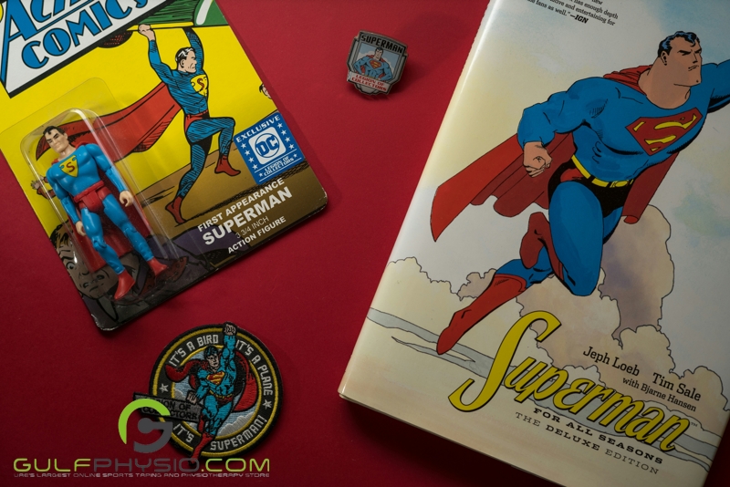 A tabletop with Superman merchandise scattered on it.